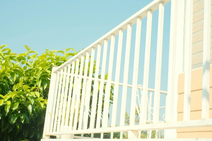 White railing against a bright blue sky